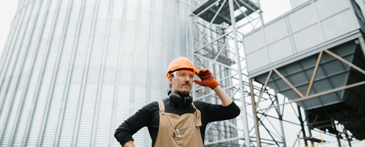 a-male-worker-in-front-of-grain-silos-2024-09-19-18-05-53-utc (1)