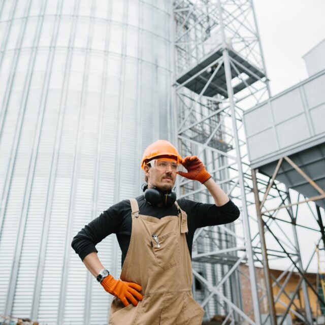 a-male-worker-in-front-of-grain-silos-2024-09-19-18-05-53-utc (1)